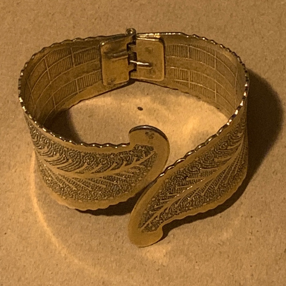 Gold tone arm bangle